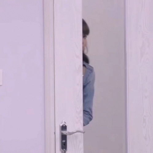 Girl Peeping On An Open Door GIF