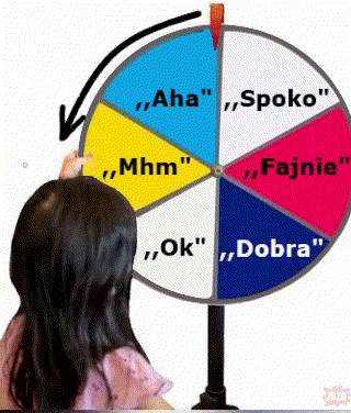 Girl Pointing at Colorful Spinning Wheel With Foreign Words