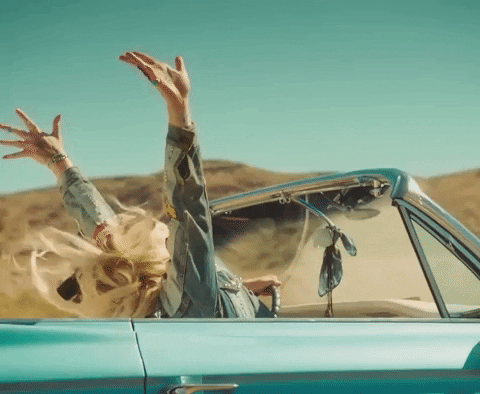Girl Raising Hands On Road Trip GIF