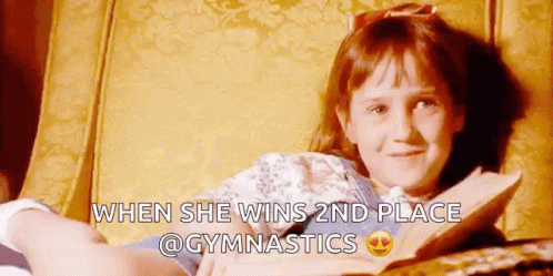 Girl Reading Book After Gymnastics Win