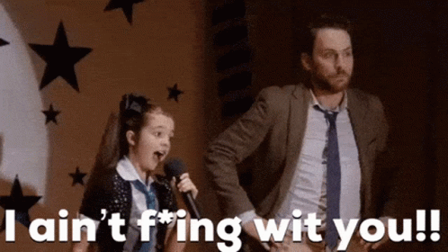 Girl Singing Into Microphone Beside Man In Suit GIF