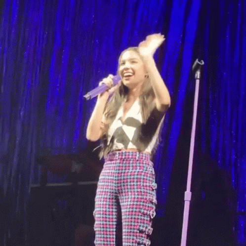 Girl Singing Into Microphone On Stage GIF