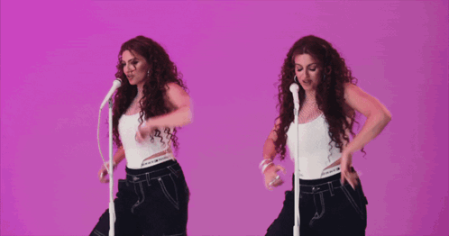 Girl Singing Into Microphone With Band Behind GIF