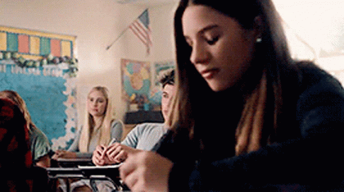 Girl Sitting at Desk in Classroom