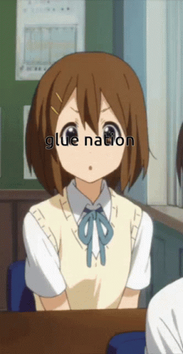 Girl Sitting at Desk with Glue Nation on Face