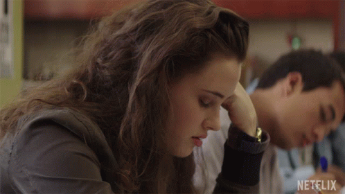 Girl Sitting At Desk With Netflix Logo GIF