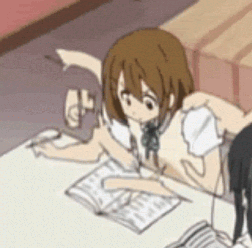 Girl Sitting at Table with Book and Pencil