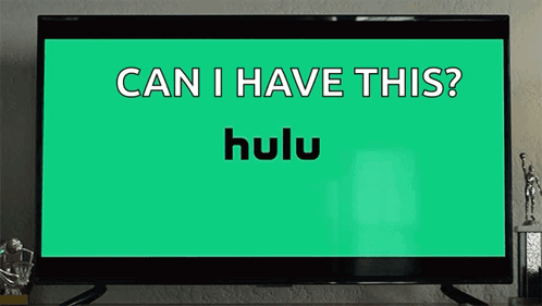 Girl Sitting At Table With Hulu Logo And Food GIF