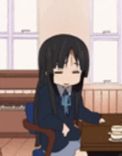 Girl Sitting at Table With Stack of Pancakes Eyes Closed