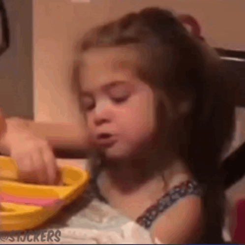 Girl Sitting at Table with Yellow Plate