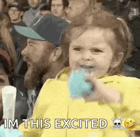 Girl Sitting in Crowd Eating Cotton Candy