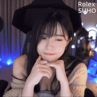 Girl Sitting in Front of Rolex Suho Logo