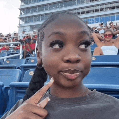 Girl Sitting in Stadium with E1 Sticker