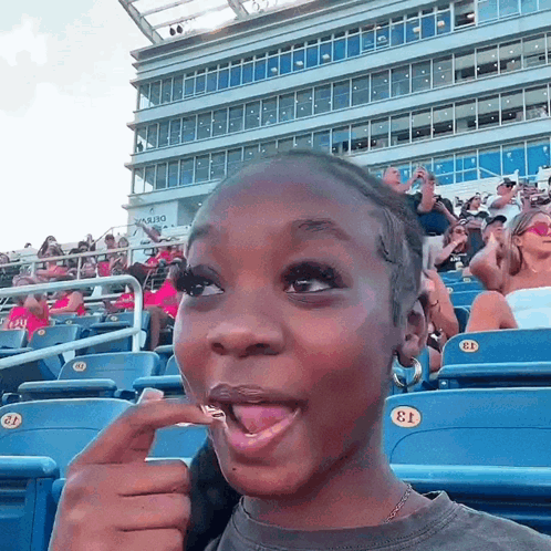 Girl Sitting in Stadium with Number 13