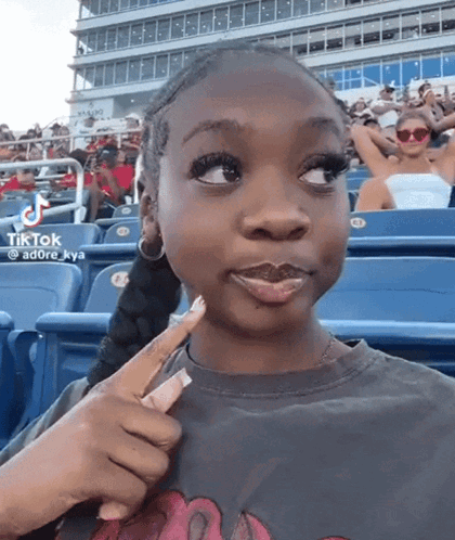 Girl Sitting in Stadium with TikTok