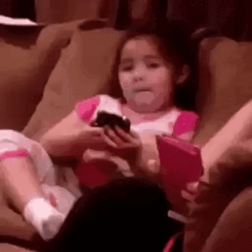 Girl Sitting on Couch Holding Phone