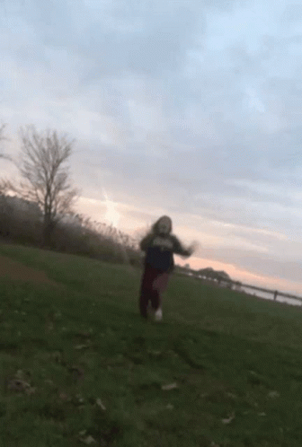 Girl Slipping On The Grass Field GIF