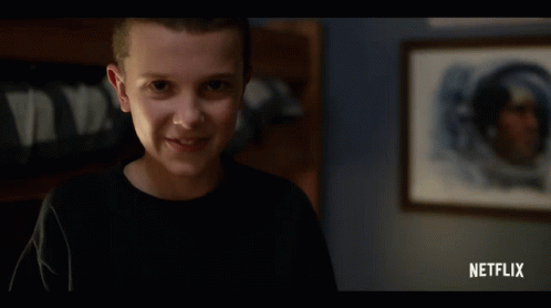Girl Smiling in Front of Netflix Ad