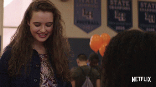 Girl Smiling In Front Of Netflix Banner GIF