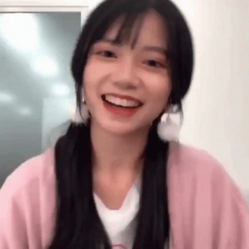 Girl Smiling in Pink Cardigan