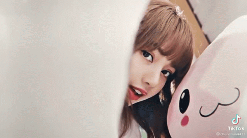 Girl Smiling Next to Stuffed Animal