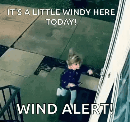 Girl Standing by Window During Wind Alert