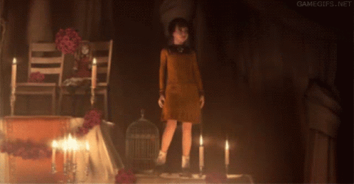 Girl Standing In Dark Room With Candles GIF