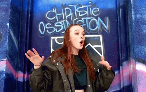Girl Standing In Front Of Christie Ossington Wall GIF
