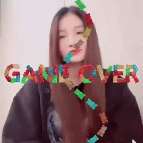 Girl Surrounded by Gummy Bears Saying Game Over