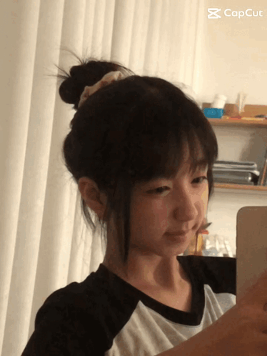 Girl Taking Selfie With CapCut Logo