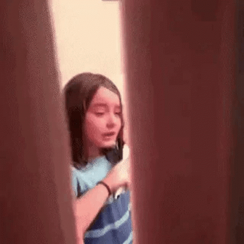 Girl Talking on Cell Phone Behind Door