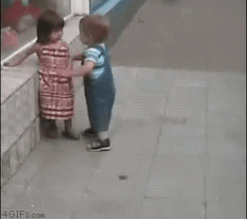 Girl Touching Boy's Face While Walking