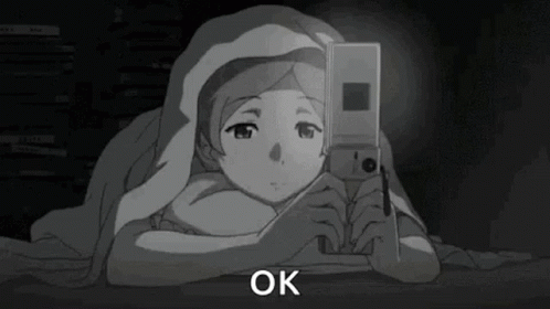 Girl Under Blanket Looking at Phone