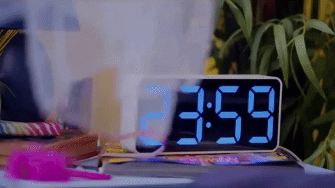 Girl Waking To Digital Clock Alarm GIF
