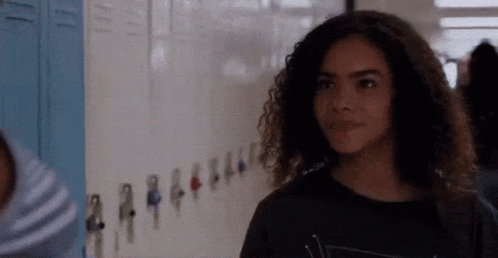 Girl With Curly Hair by School Lockers