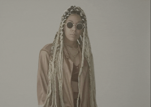 Girl With Dreads Looks Over Your Head GIF