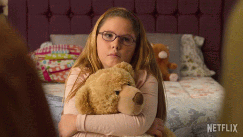 Girl With Glasses Hugging Teddy Bear Netflix Logo