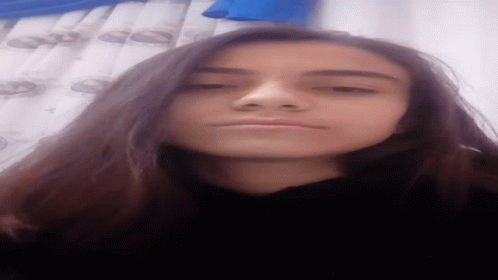 Girl With Long Dark Hair Taking Selfie Blue Curtain