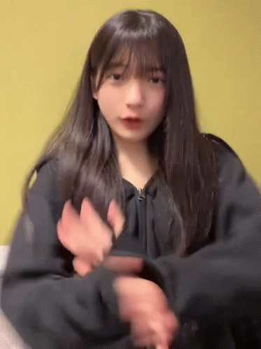 Girl With Long Hair and Bangs Dancing in Black Jacket