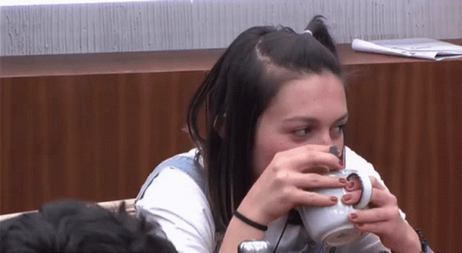 Girl With Obvious Secret Drinking Cup GIF