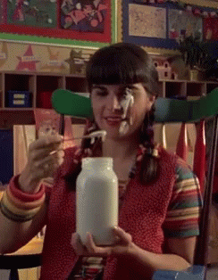 Girl With Pigtails Holding Milk Jar GIF