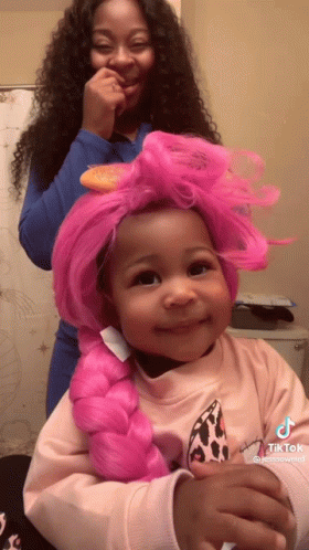 Girl with Pink Braided Wig Being Brushed