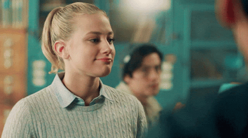 Girl With Ponytail In Blue Sweater Smiling GIF