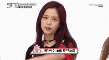Girl With Purple Hair Pointing at Camera Pick