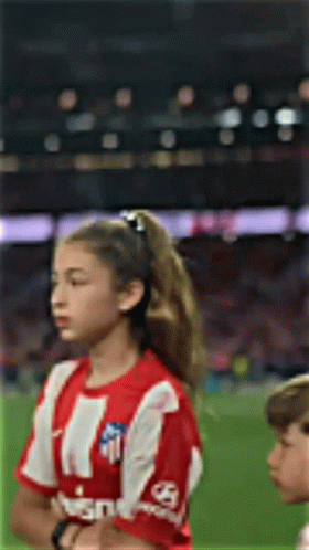 Girl with Red-and-White Striped Shirt Eyes Closed Soccer Field