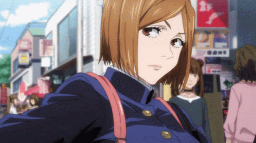 Girl With Short Brown Hair Walking Past Sign Saying A
