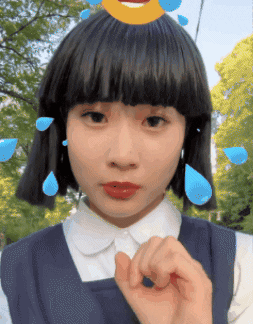 Girl With Smiley Face On Head Making Hand Gesture GIF