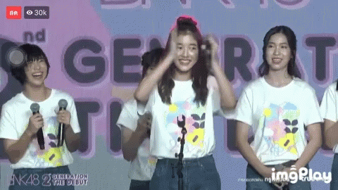 Girls at Microphones With Generation Sign