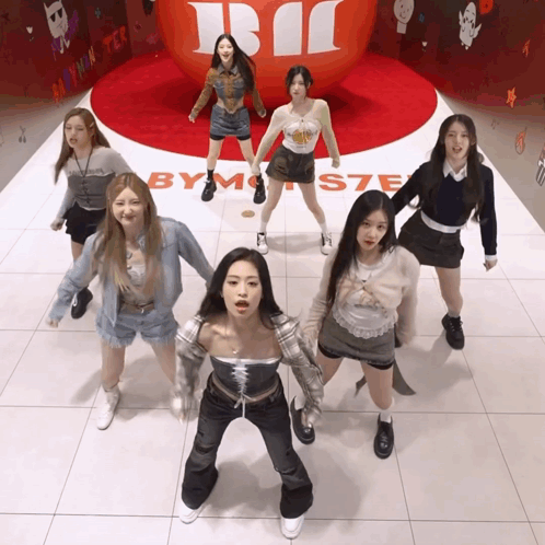 Girls Dancing in Front of By Monster Sign