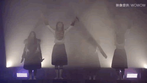 Girls Dancing On Stage With Chinese Writing GIF
